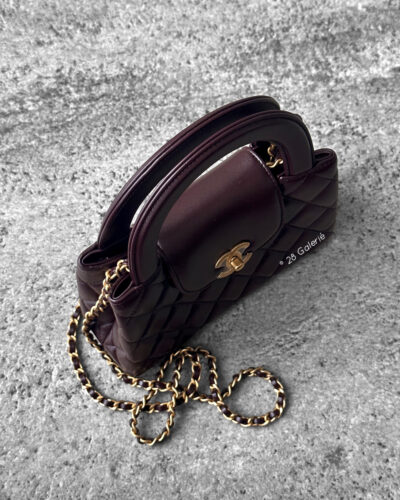 Chanel Dark Brown Mini Kelly Shopping Tote in shiny calfskin leather with gold hardware. A chic, structured design that blends elegance with everyday style.
