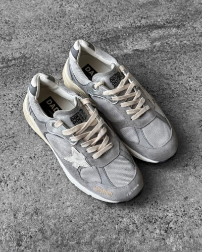 Golden Goose Dad-Star sneakers in suede and silver mesh, combining retro-inspired style with signature distressed detailing.