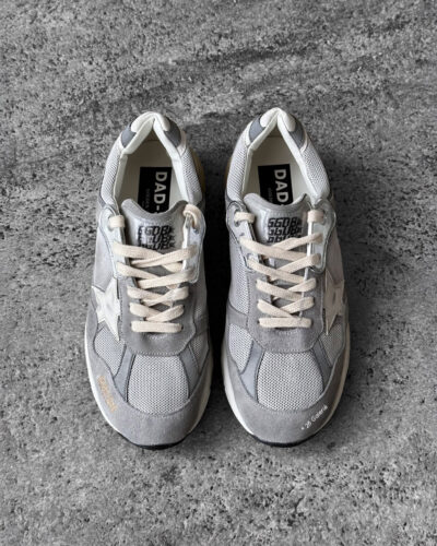 Golden Goose Dad-Star sneakers in suede and silver mesh, combining retro-inspired style with signature distressed detailing.