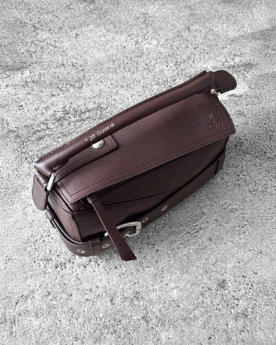 Loewe Small Dark Brownie Puzzle Biker Bag in calfskin leather, blending the iconic Puzzle design with bold biker-inspired detailing.