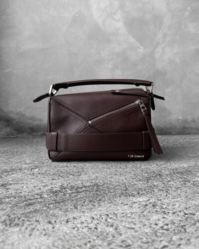 Loewe Small Dark Brownie Puzzle Biker Bag in calfskin leather, blending the iconic Puzzle design with bold biker-inspired detailing.