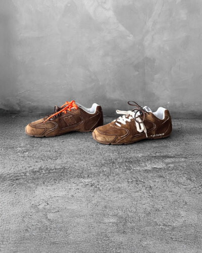 Miu Miu x New Balance 530 SL sneakers in cinnamon suede leather, merging sporty design with luxury craftsmanship.