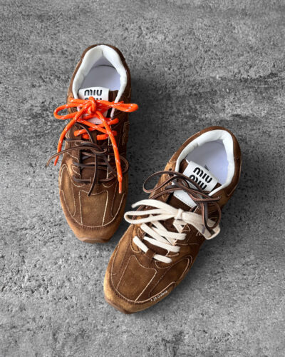 Miu Miu x New Balance 530 SL sneakers in cinnamon suede leather, merging sporty design with luxury craftsmanship.