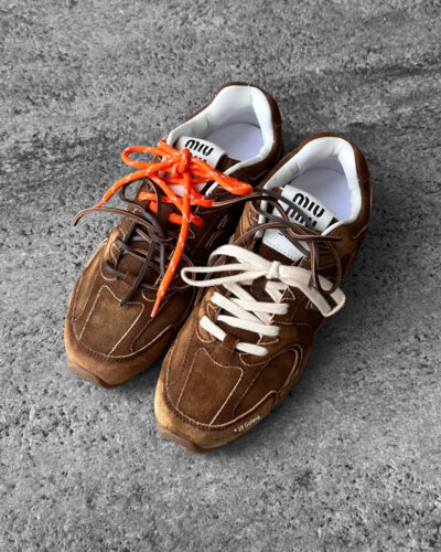 Miu Miu x New Balance 530 SL sneakers in cinnamon suede leather, merging sporty design with luxury craftsmanship.