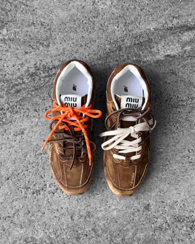 Miu Miu x New Balance 530 SL sneakers in cinnamon suede leather, merging sporty design with luxury craftsmanship.