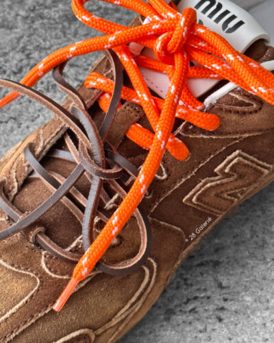 Miu Miu x New Balance 530 SL sneakers in cinnamon suede leather, merging sporty design with luxury craftsmanship.