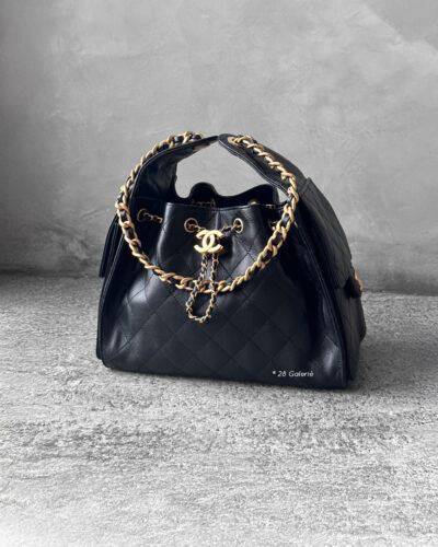 Small Black C25 Quilted Caviar bag with aged gold-tone hardware. A classic, compact design that exudes timeless elegance and versatile style.