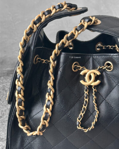 Small Black C25 Quilted Caviar bag with aged gold-tone hardware. A classic, compact design that exudes timeless elegance and versatile style.