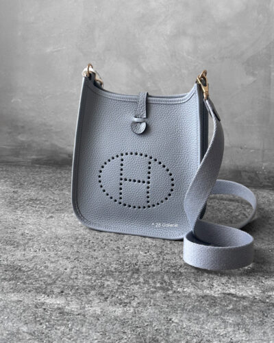 Hermès Bleu Glacier Evelyne 16 Amazone Bag, a compact crossbody in Clemence leather with signature perforated H logo and canvas strap.