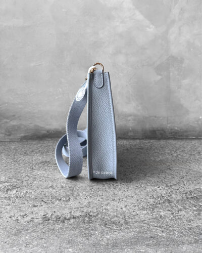 Hermès Bleu Glacier Evelyne 16 Amazone Bag, a compact crossbody in Clemence leather with signature perforated H logo and canvas strap.